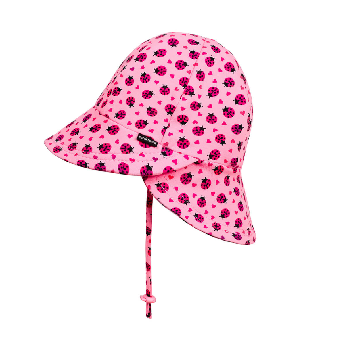 Pink children&#39;s sun hat with ladybug pattern on a white background