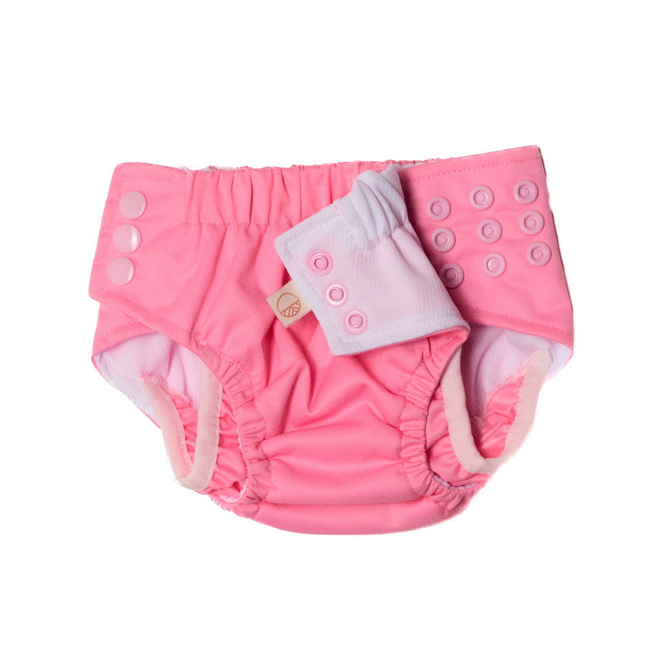 Pink baby diaper with a matching cover on a white background
