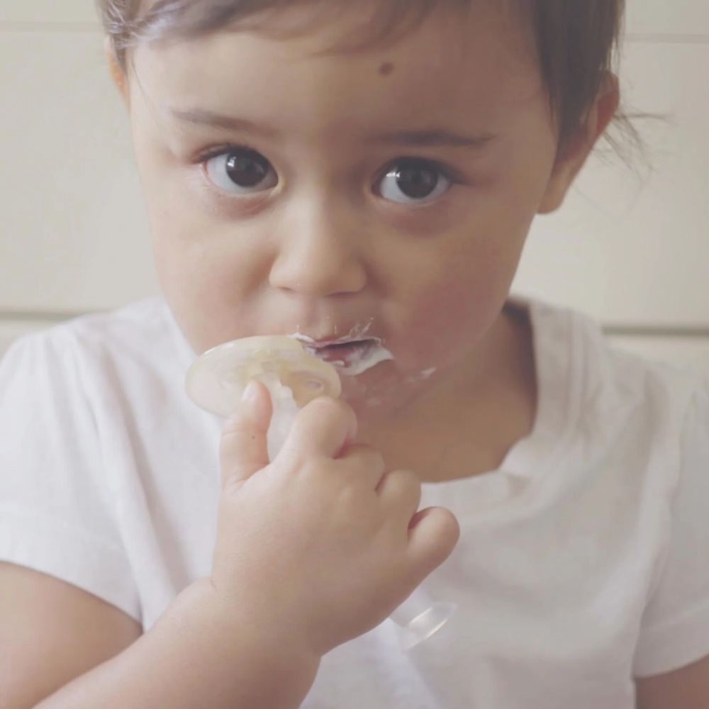 Baby brushing their teeth using the Haakaa 360 Toothbrush