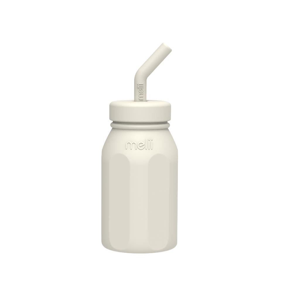 White bottle with straw lid on a white background