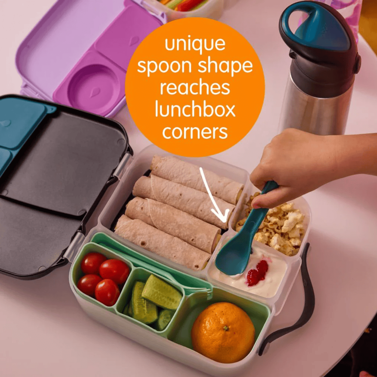 Lunchbox with compartments filled with food, a hand using a unique spoon to reach into the lunchbox, and text highlighting the spoon's design.