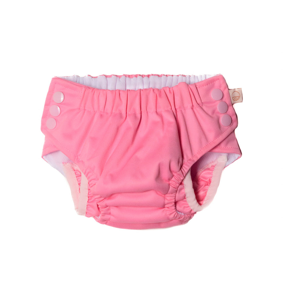 Pink baby diaper with button closure on a white background