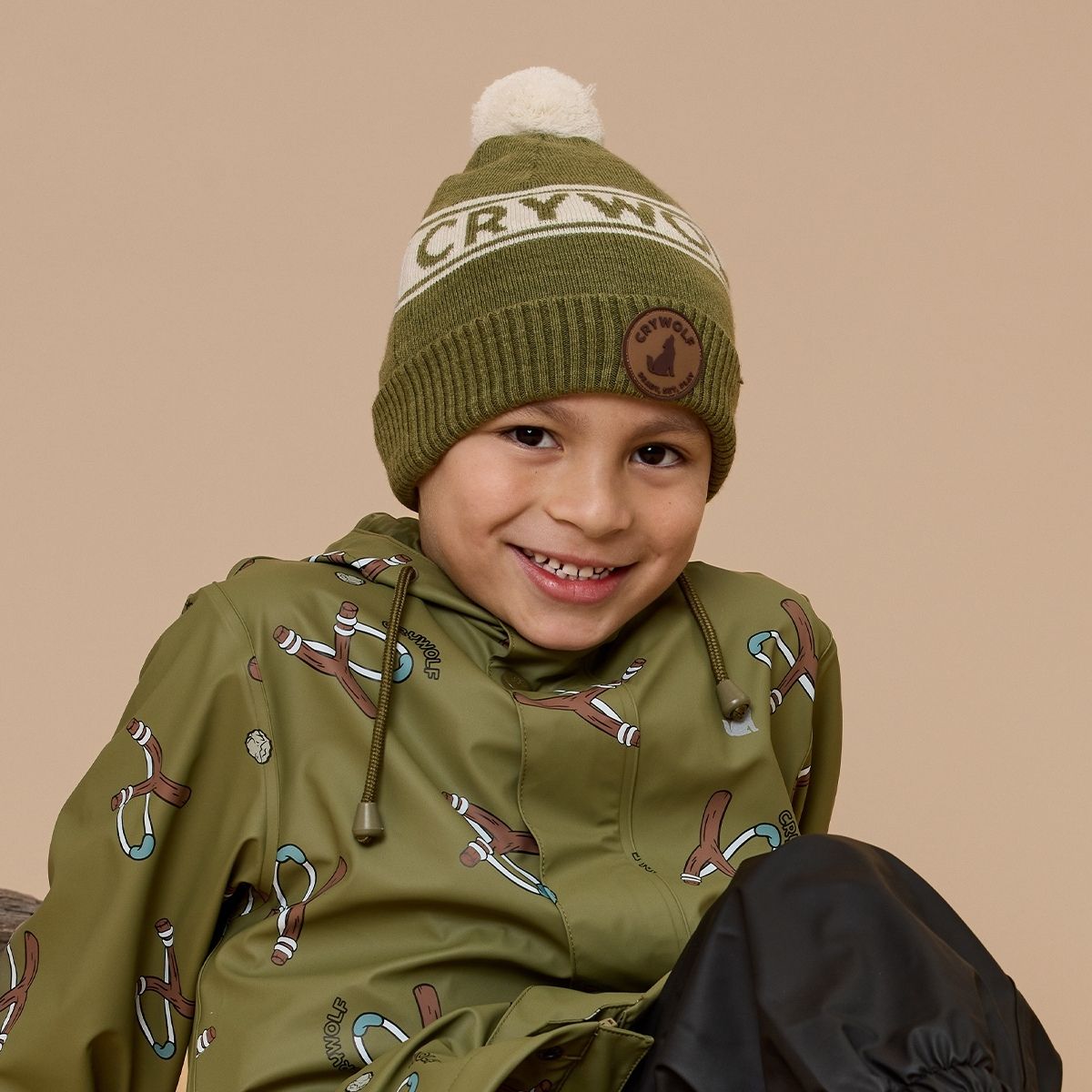 A closeup shot of a boy wearing the fern alpine beanie.