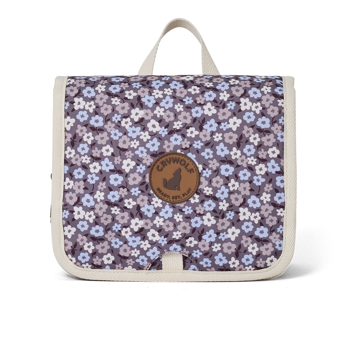 A hanging toiletry bag with a purple flower design for kids to take away on holiday or to keep their bathroom organised.