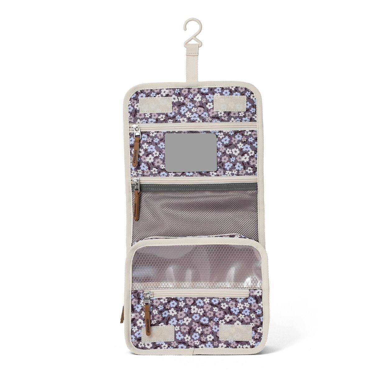 The toiletry bag hanging open to show the pockets and mirror.