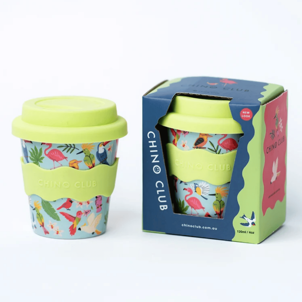 A reusable travel tumbler with a tropical flamingo and bird print, a light green silicone sleeve, and a matching light green lid, shown next to its branded retail box on a white background.