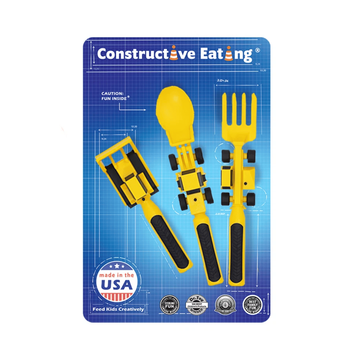 A set of three yellow and black toy construction vehicles designed as utensils (spork, shovel, fork) on a blue blueprint-style backing card. The card features the text 'Constructive Eating' and a 'Made in the USA' badge.