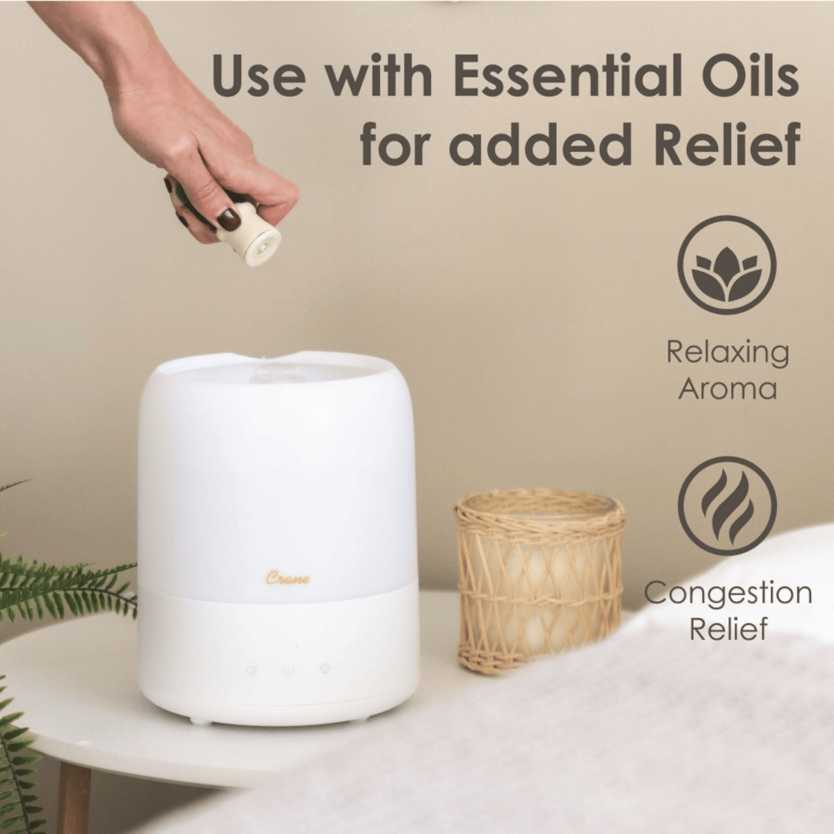 White diffuser on a table with a hand adding essential oil, text about uses, and icons.