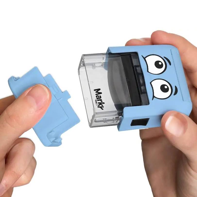 Blue stamp with cartoonish eyes held by a person on a white background