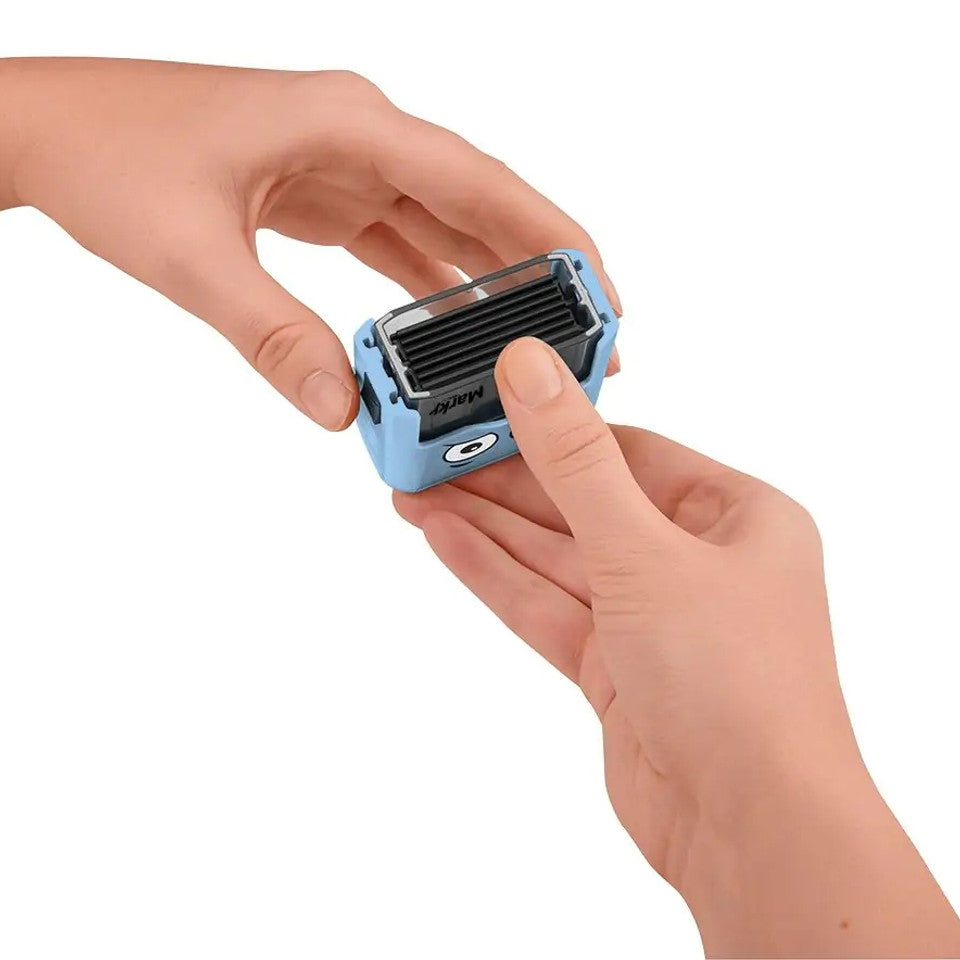 Small blue and black device held in a hand against a white background