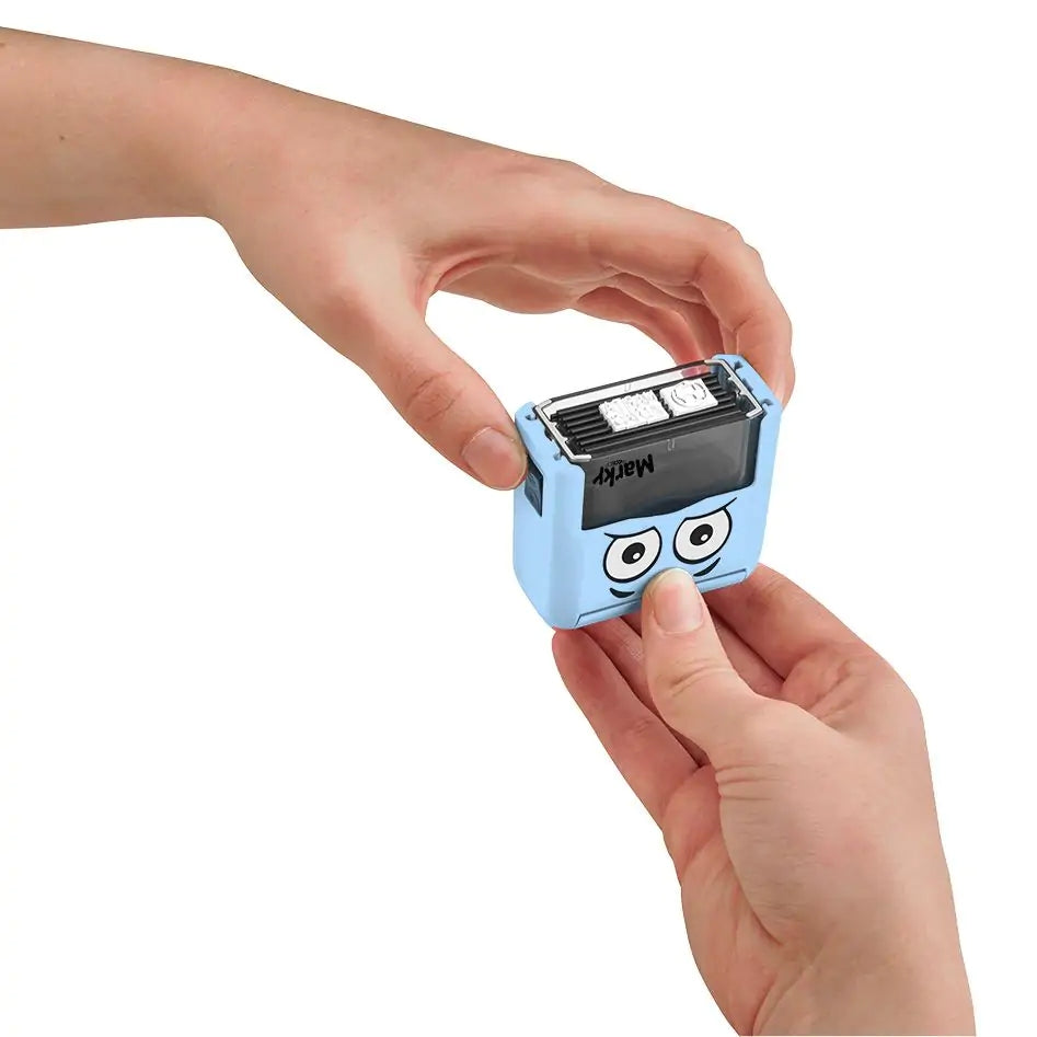 Small blue stamp with cartoon face held by a person's hand on a white background