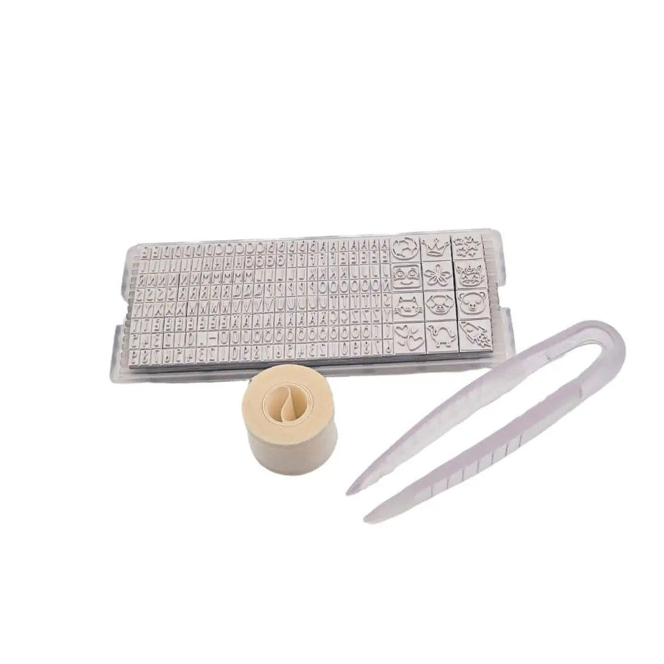 Set of stamps, a rubber stamp pad, and a white tool on a white background