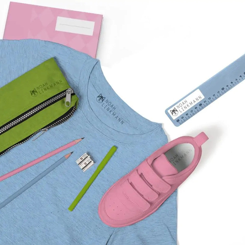 Blue t-shirt with pink shoes, green pencil case, pink pencils, and ruler on a white background