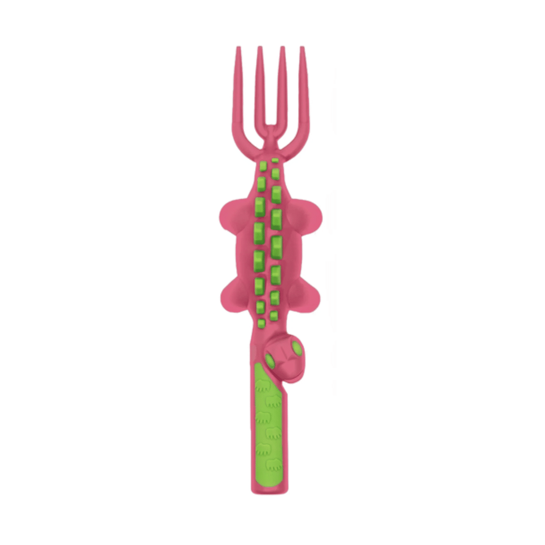 Pink children&#39;s fork with green handle shaped as dinosaur on a white background