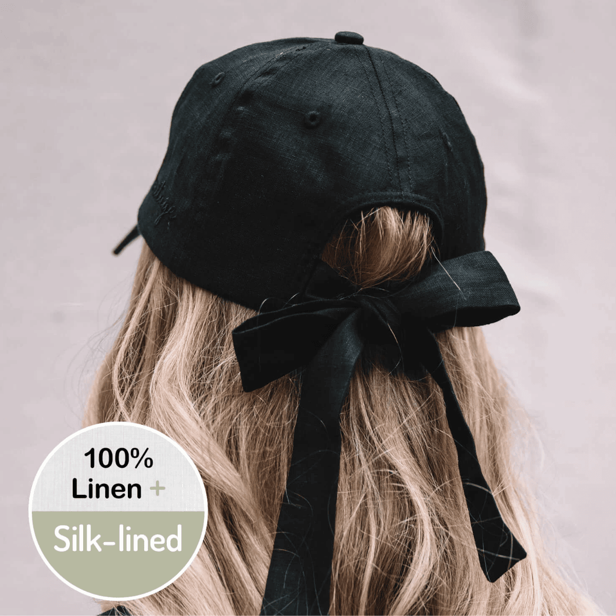 Black linen cap with a bow on a neutral background