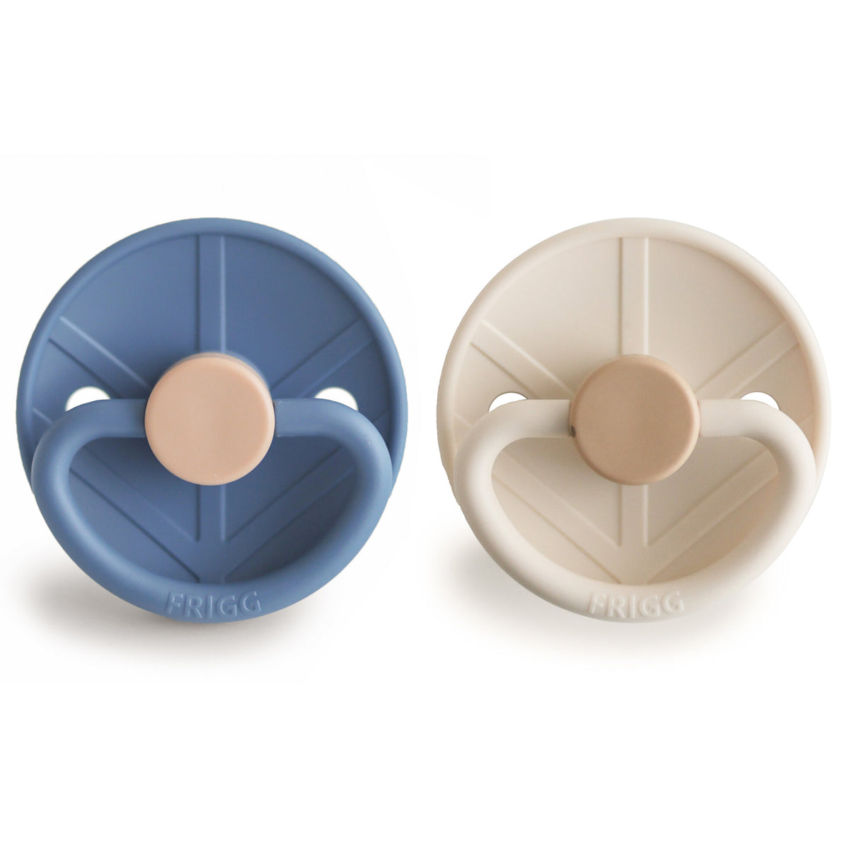 Two pacifiers, one blue and one beige, on a white background with 'FRIGG' branding.