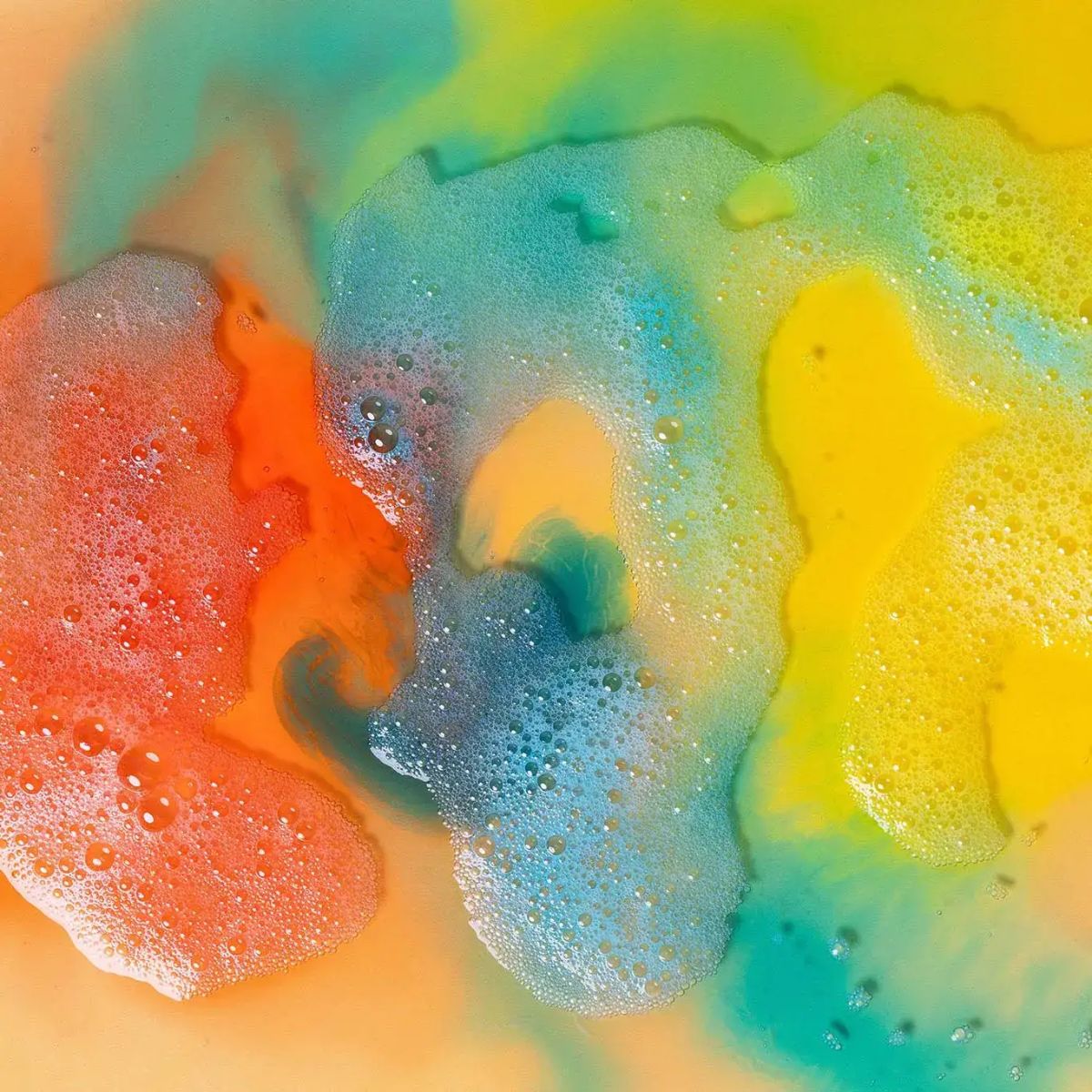 Colorful foam texture with orange, yellow, and blue hues.