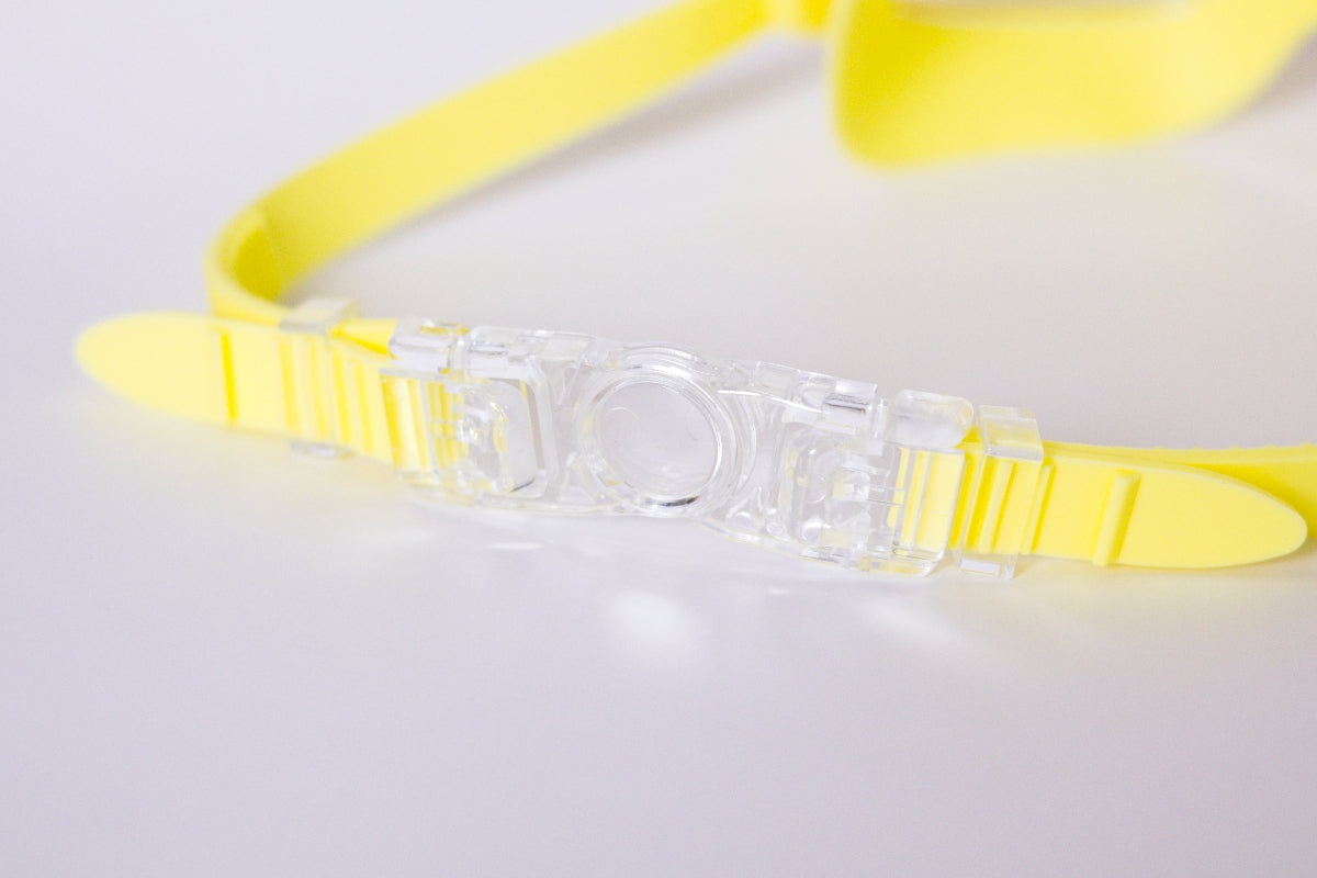 Yellow goggles on a light gray background