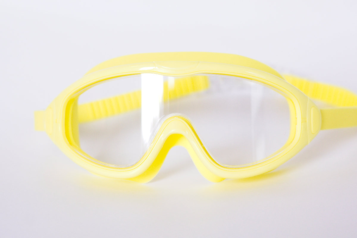 Yellow goggles on a light gray background