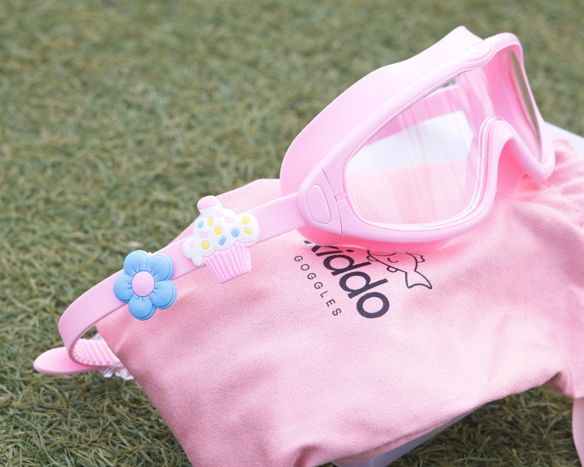 Pink goggles with decorative elements on a pink background
