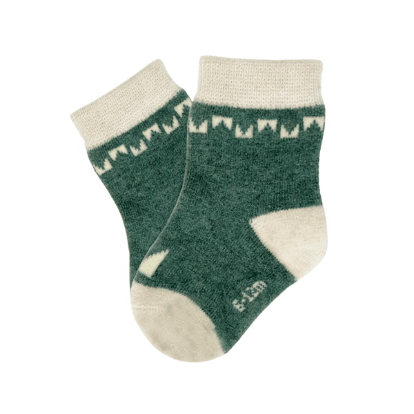 Green socks with white patterns on a white background