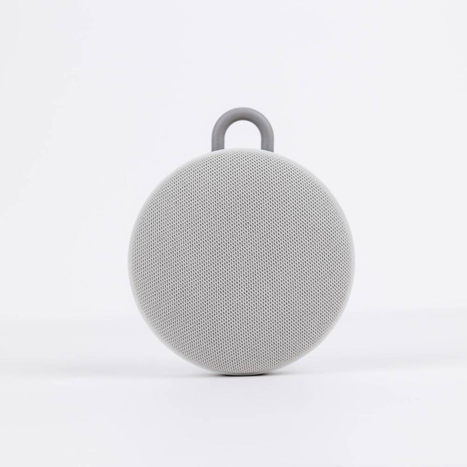 Gray portable speaker on a white background