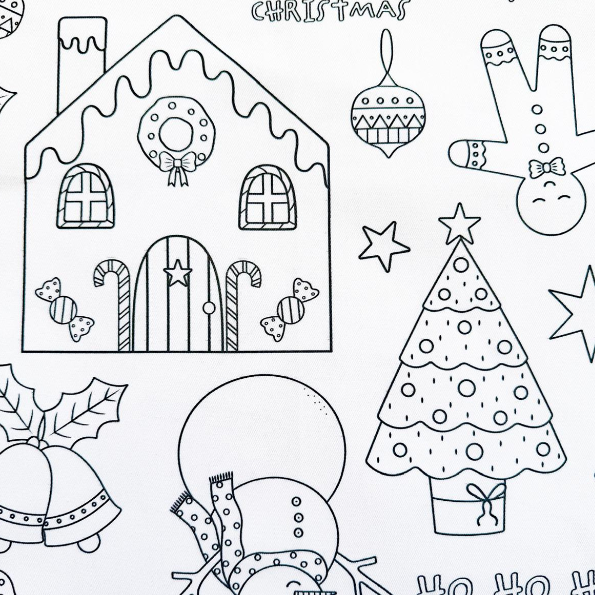 Coloring page with Christmas-themed illustrations including a gingerbread house, tree, and presents.