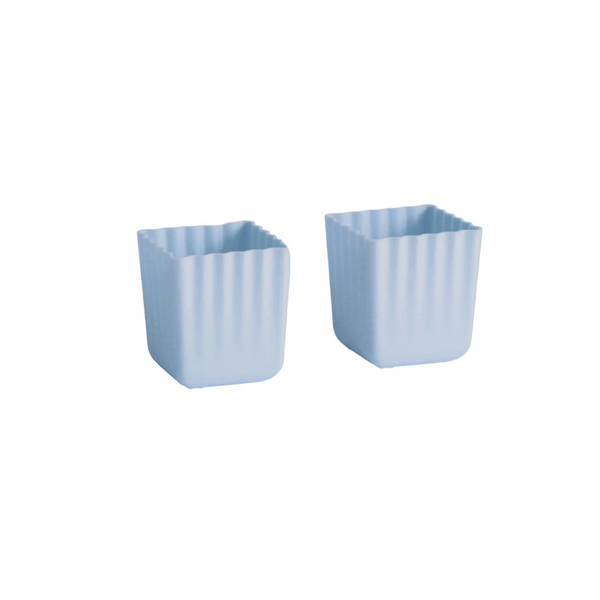 Two light blue square cup holders with vertical fluted sides, shown on a plain white background.