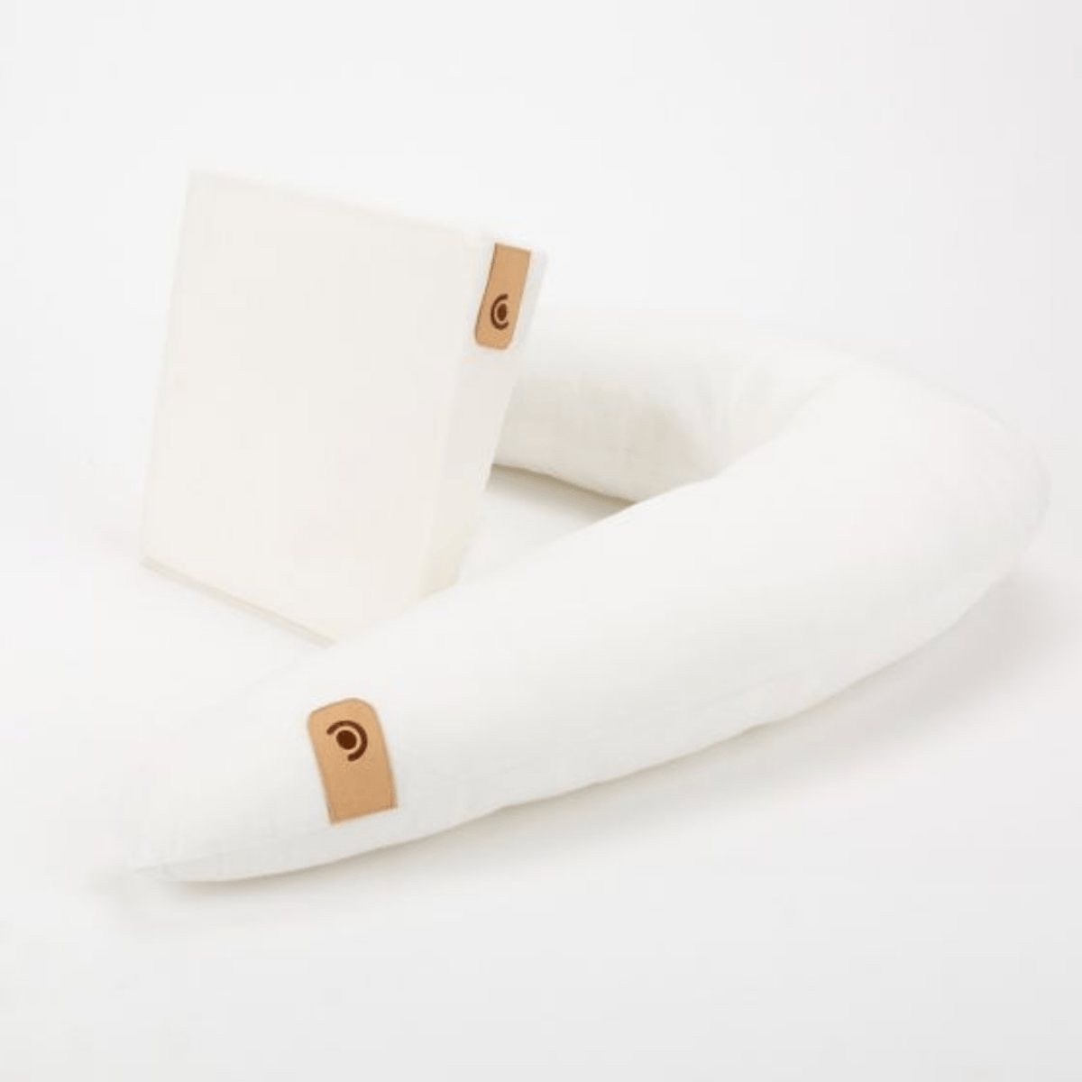 White pillow with a brown tag on a white background