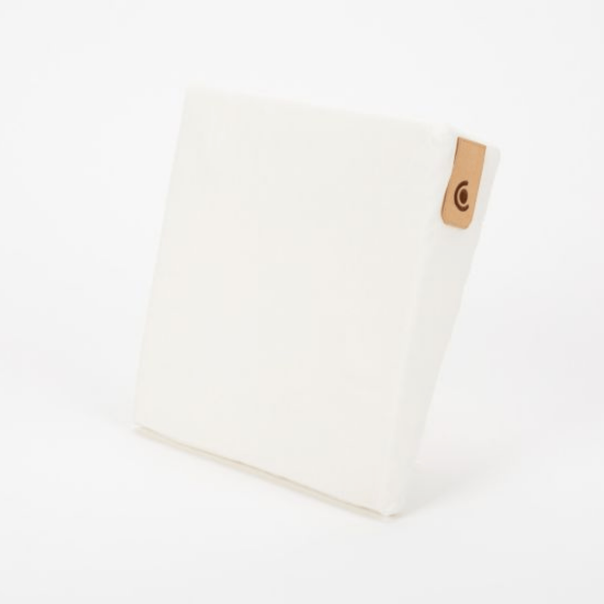 White wedge with a brown leather strap on a white background