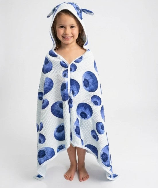 Child wearing a blue and white patterned hooded towel on a plain background