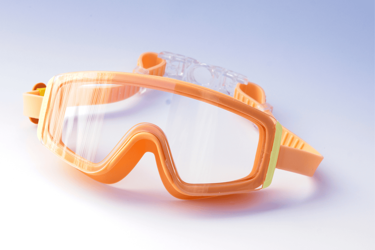 Orange Kids goggles on a light blue background