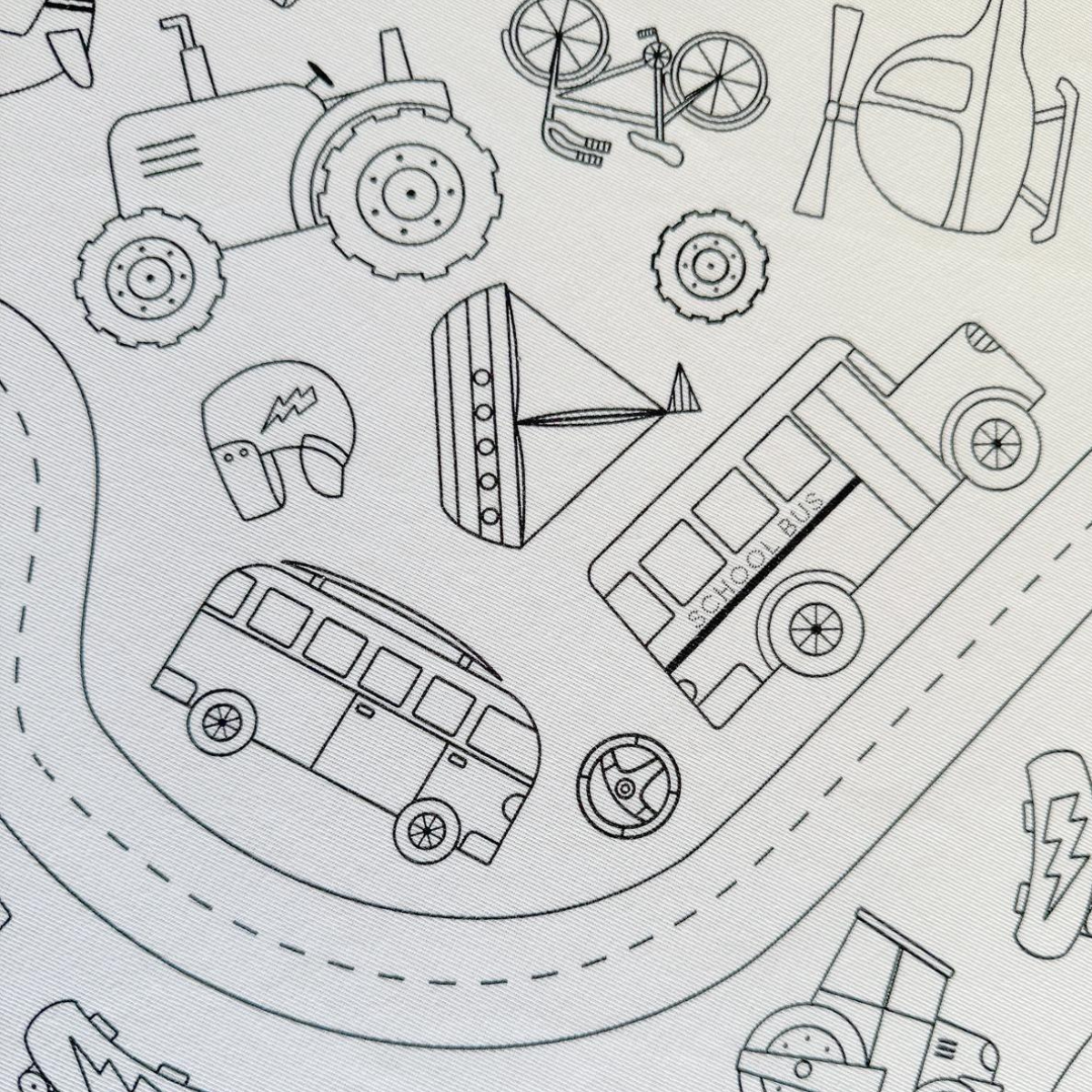 Coloring table cloth with various transportation vehicles and road layout.