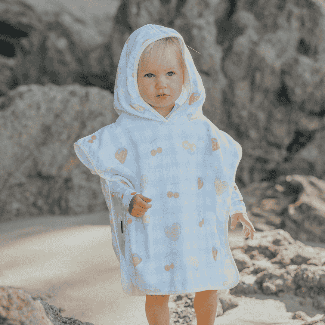 A girl wearing the colourful fruits hooded towel.