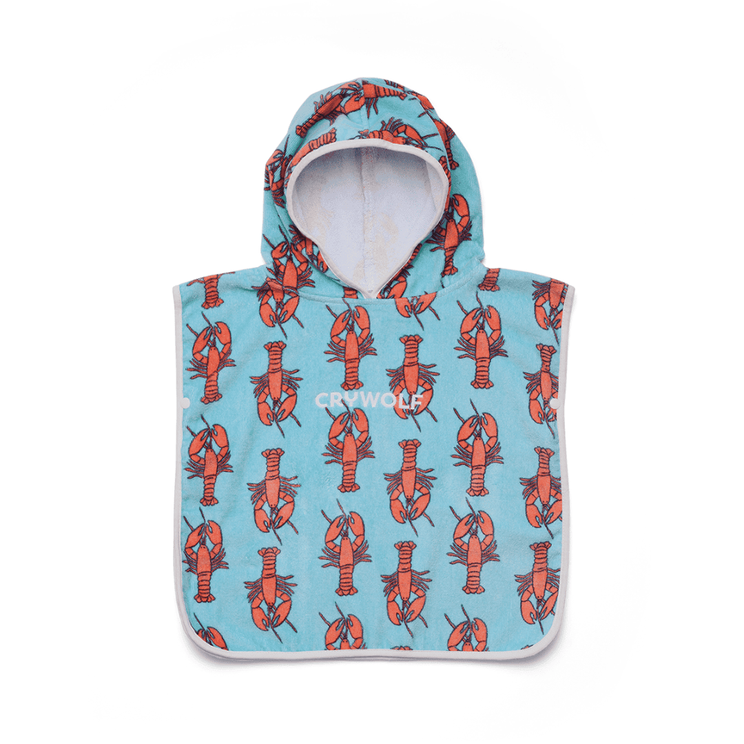 A baby hooded towel with red lobsters on a plain whitebackground.