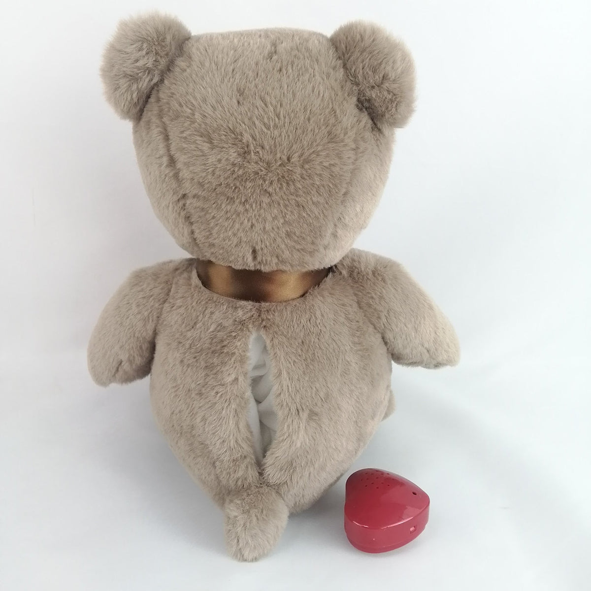 Plush bear toy with a brown bow. Has heart that records a short message or your babies heartbeat while in utero.