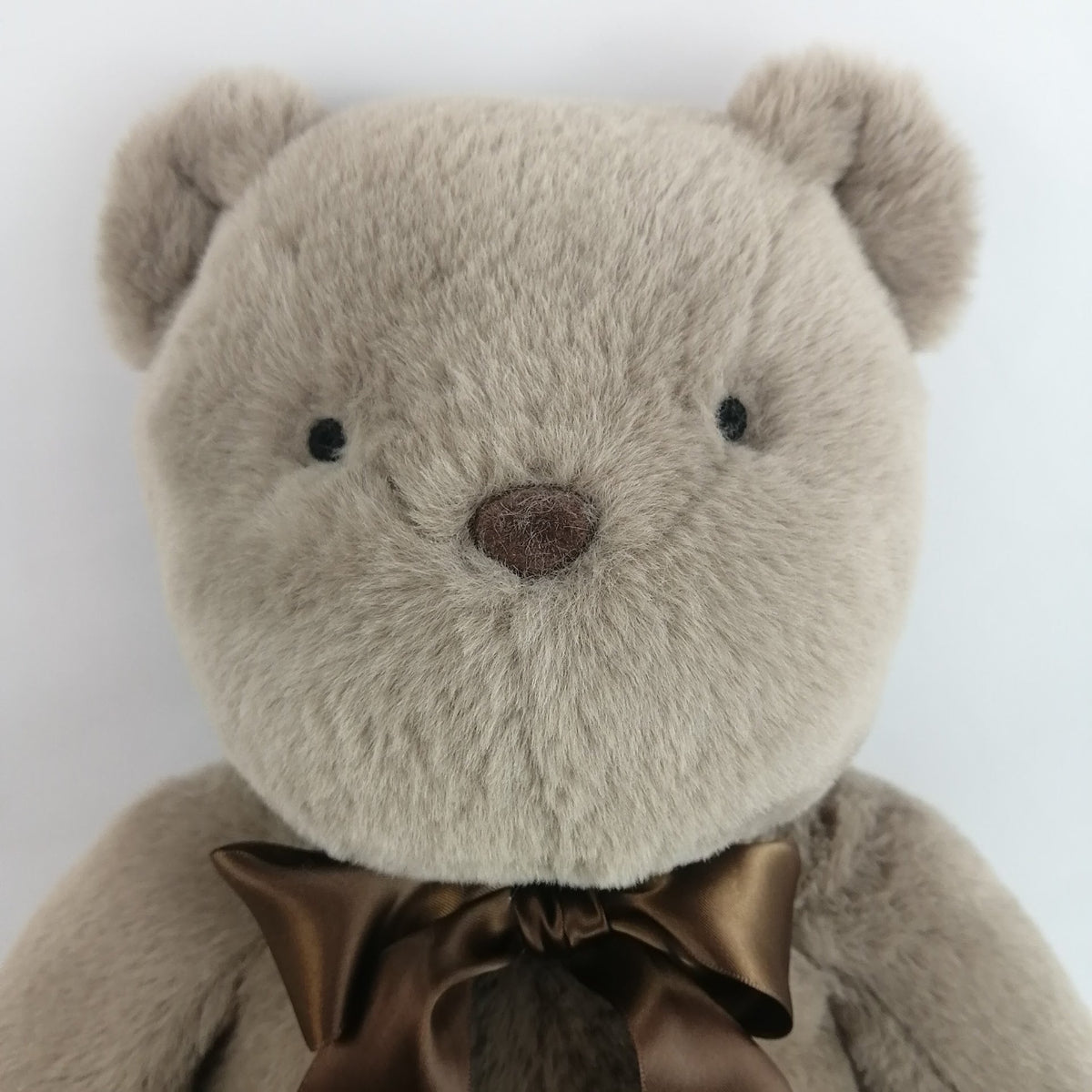 Plush bear toy with a brown bow. Has heart that records a short message or your babies heartbeat while in utero.