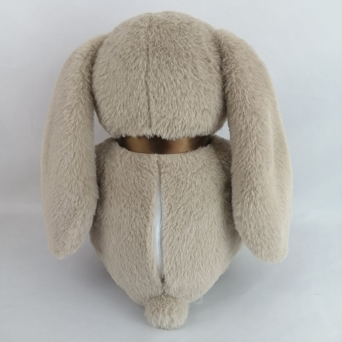 Plush bunny toy with a brown bow. Has heart that records a short message or your babies heartbeat while in utero.