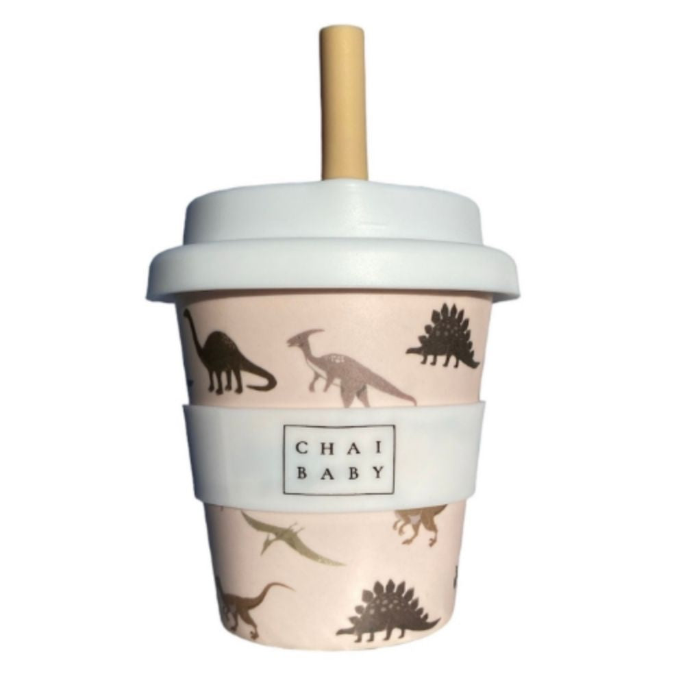 A pink bamboo children's cup with a silicone lid and a red straw, decorated with dinosaur patterns and the brand name 'Chai Baby' displayed on the front.
