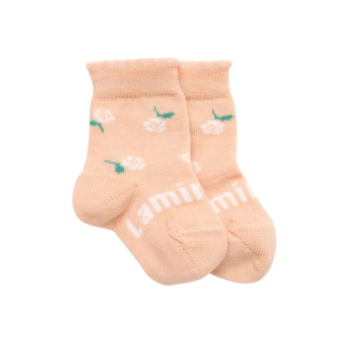 Pair of light pink socks with floral patterns on a white background