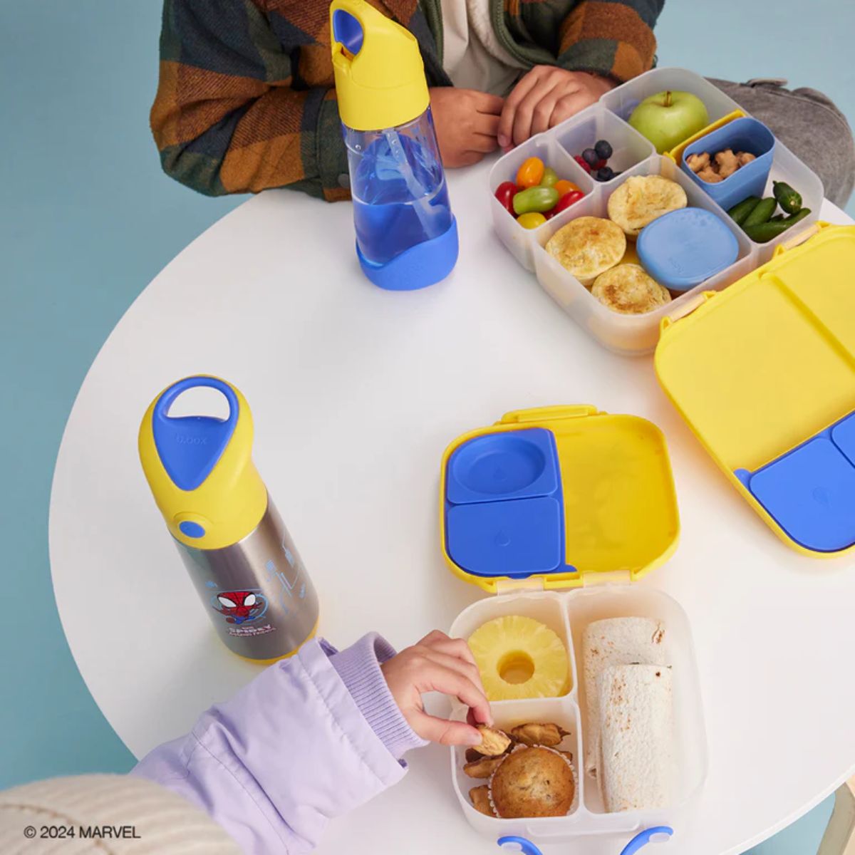 Kids enjoying their lunch using the b.box spider man range.