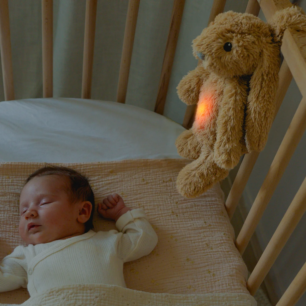 Ro using white noise to help the baby sleep. Hanging onto the cot.