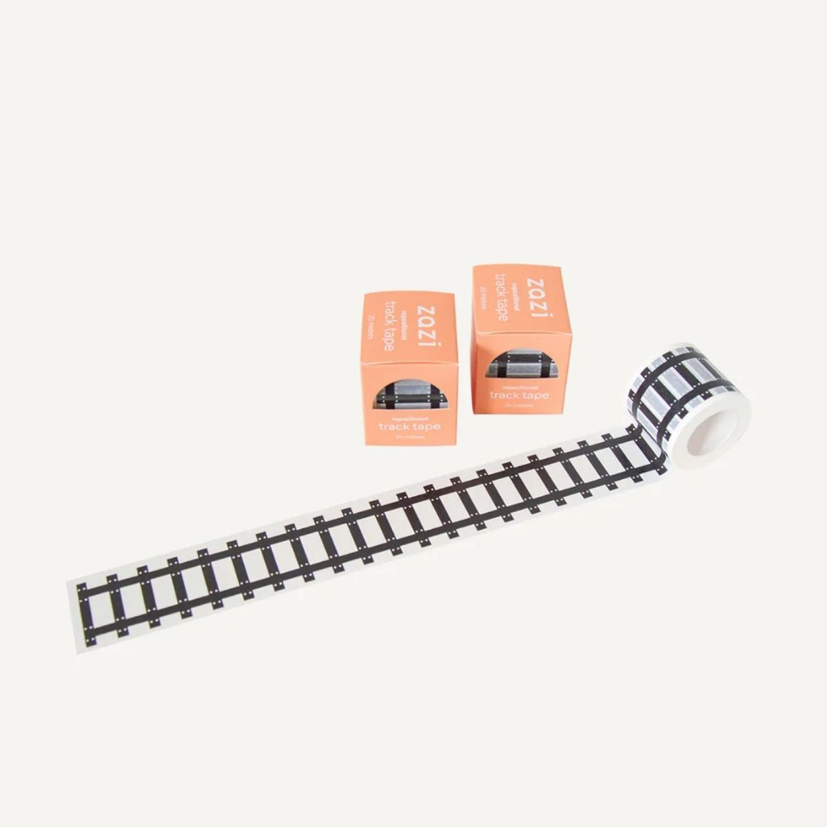 Roll of railroad track-themed tape with two boxes on a white background